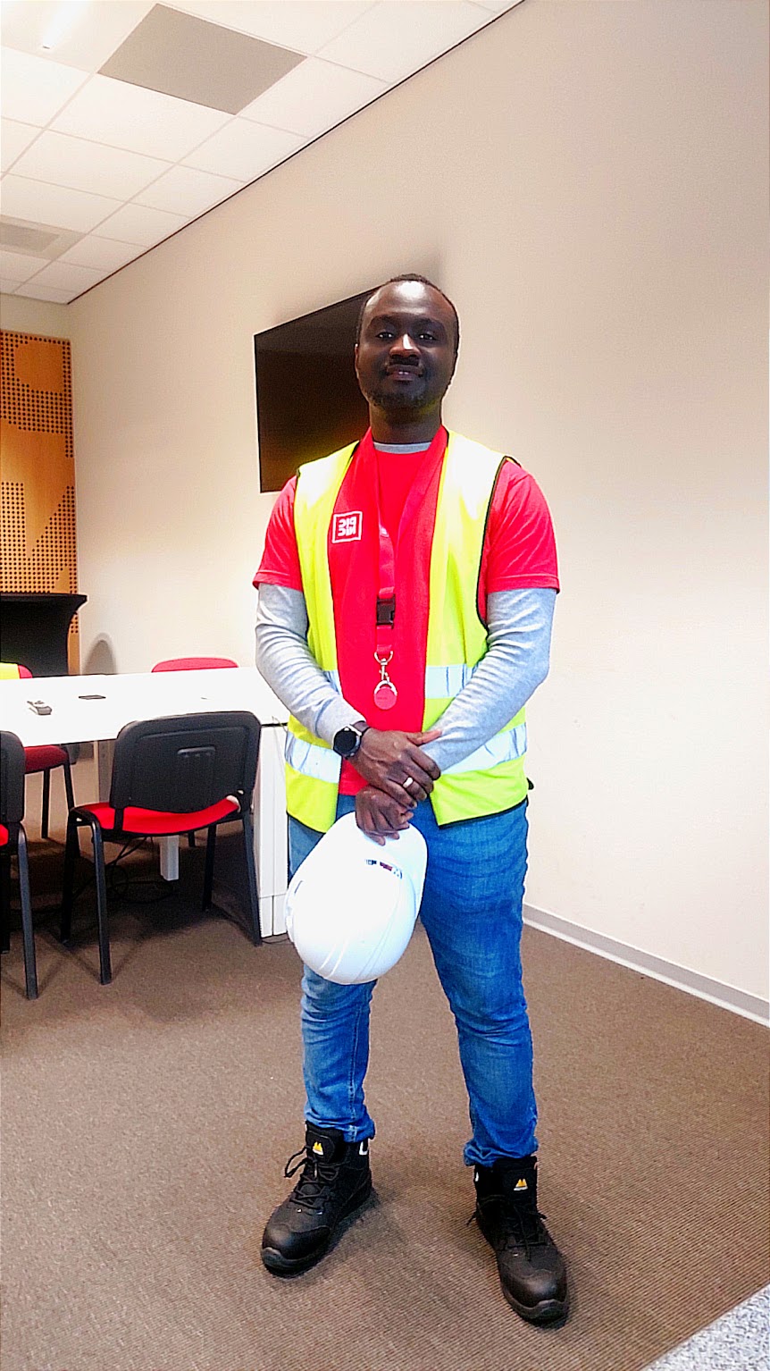 Ebenezer in Picnic hi-vis vest holding a hard hat